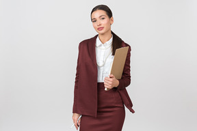 Attractive formally dressed woman holding a clipboard