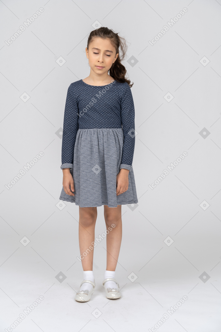 Full length of a girl standing with her eyes closed