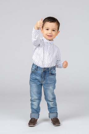 Little boy showing thumb up
