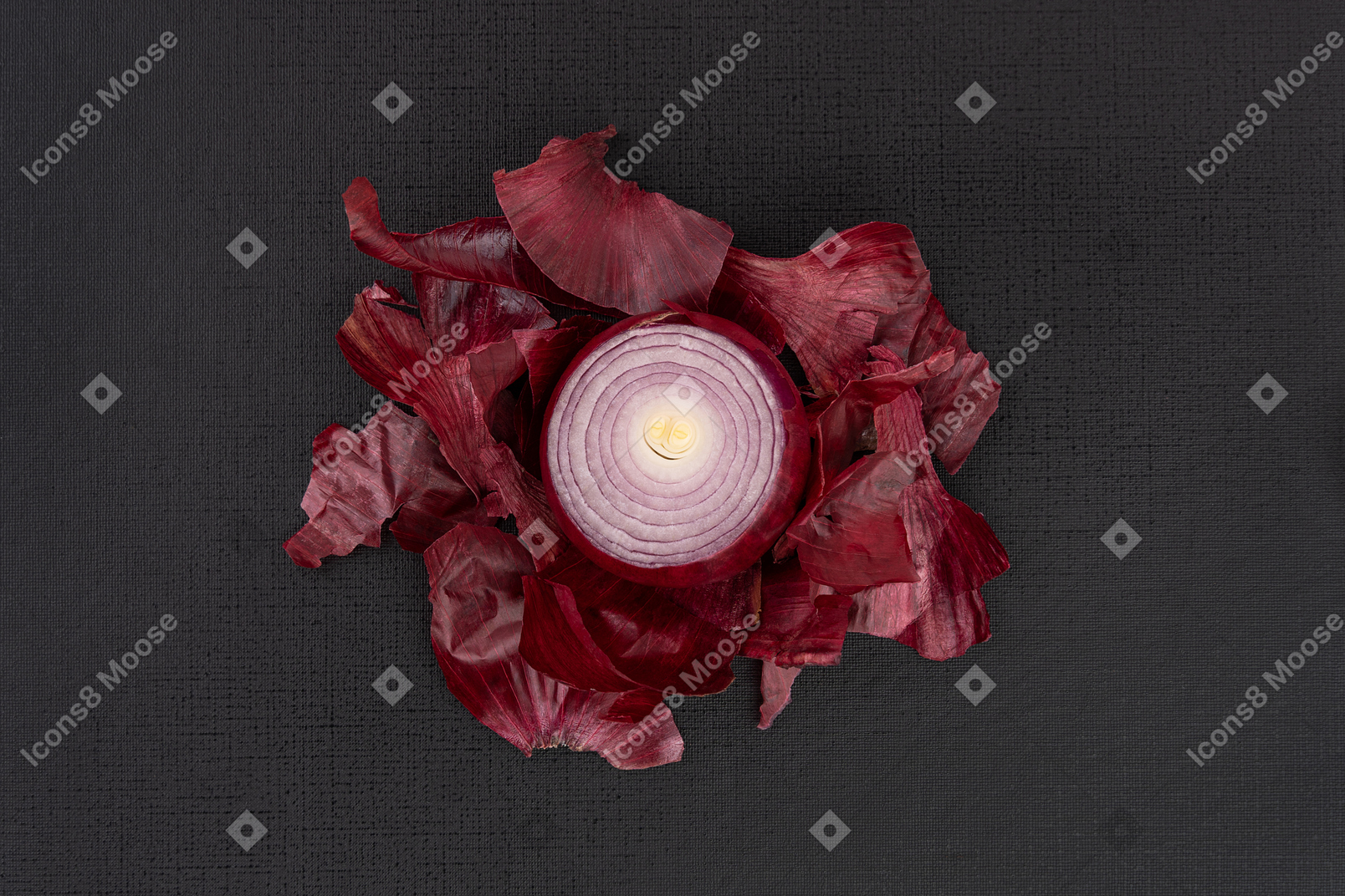 Red onion and its skins on black background
