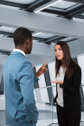 A woman talking to a man in a suit