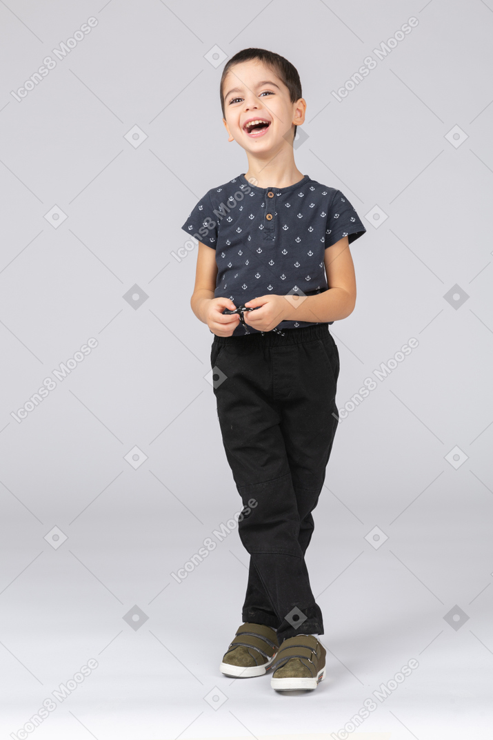 Front view of a cute boy laughing and looking up