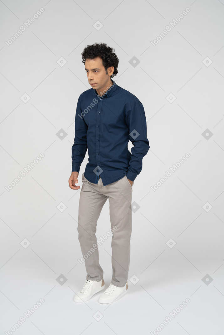 Front view of a man in casual clothes posing with hand in pocket