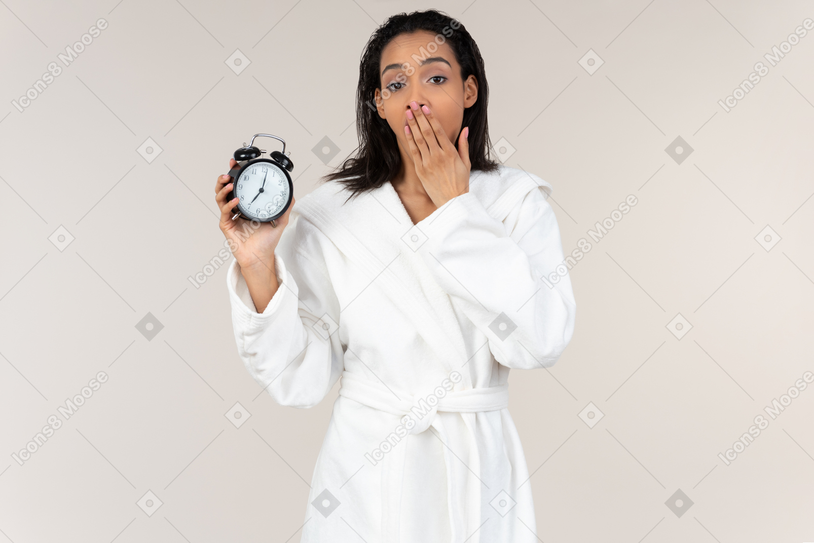 Black woman in white bathrobe going about her morning routine