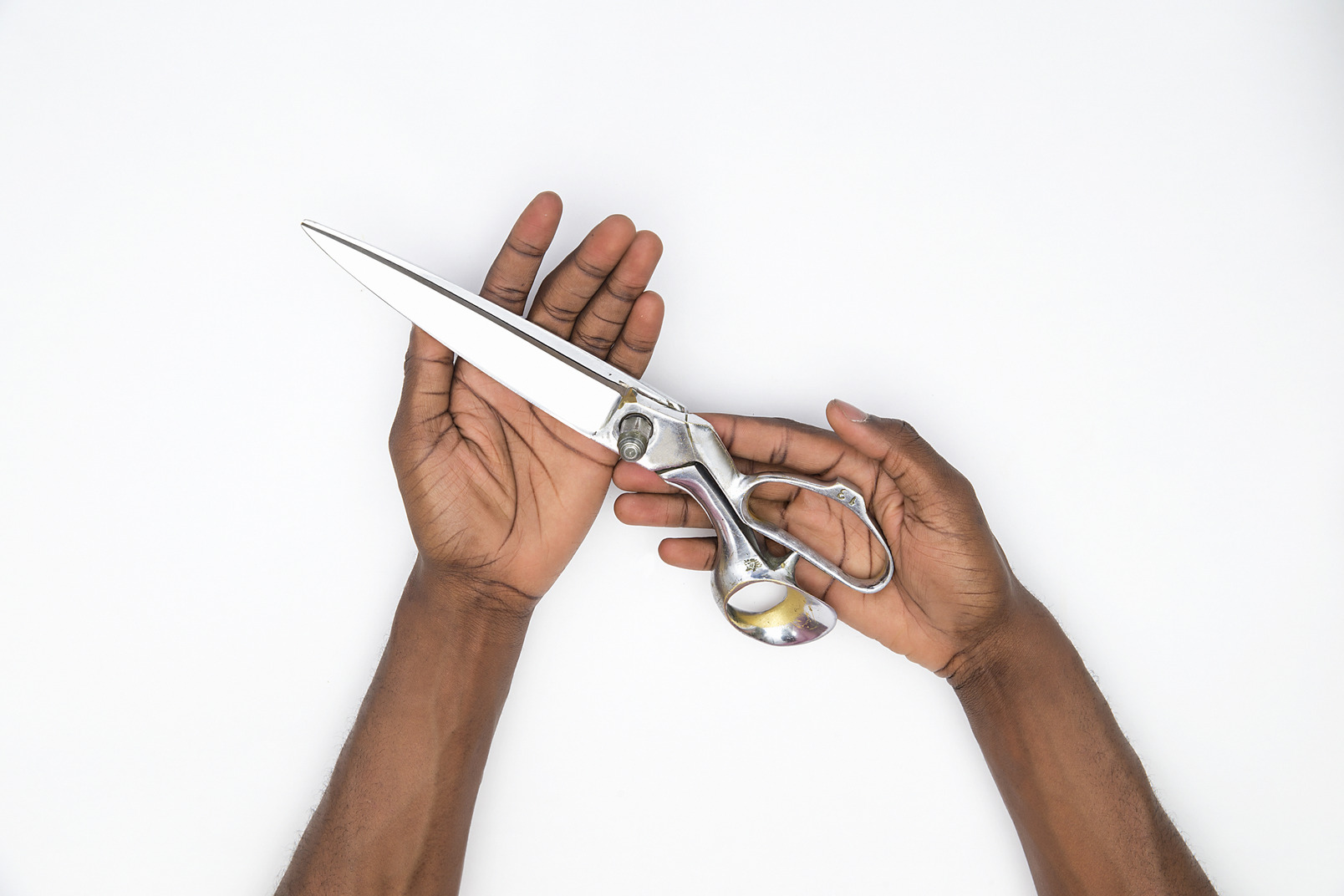 Male hands holding big scissors