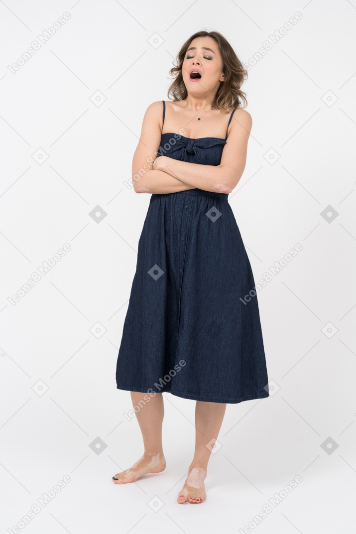 Young woman with crossed arms is about to sneeze