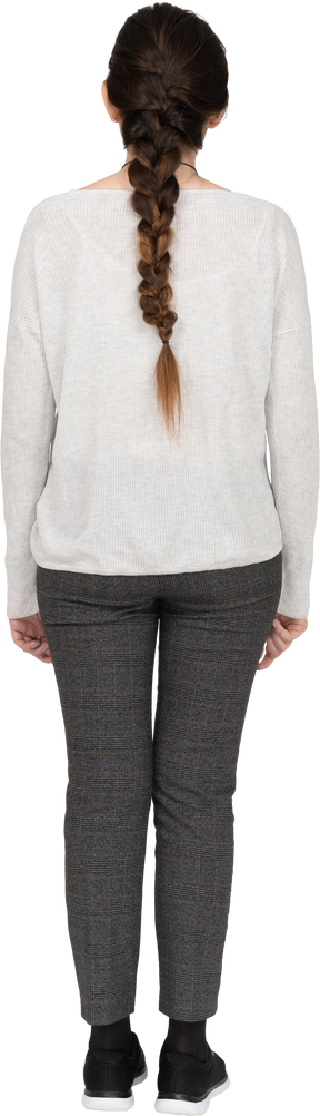 Delgada mujer caucásica con largo cabello castaño posando de espaldas a la cámara aislada sobre fondo blanco.