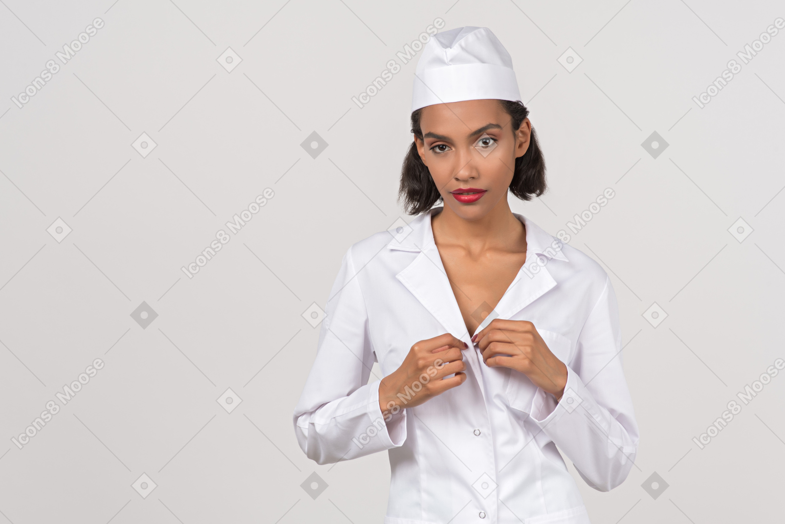 Attractive female doctor undoing button of her coat