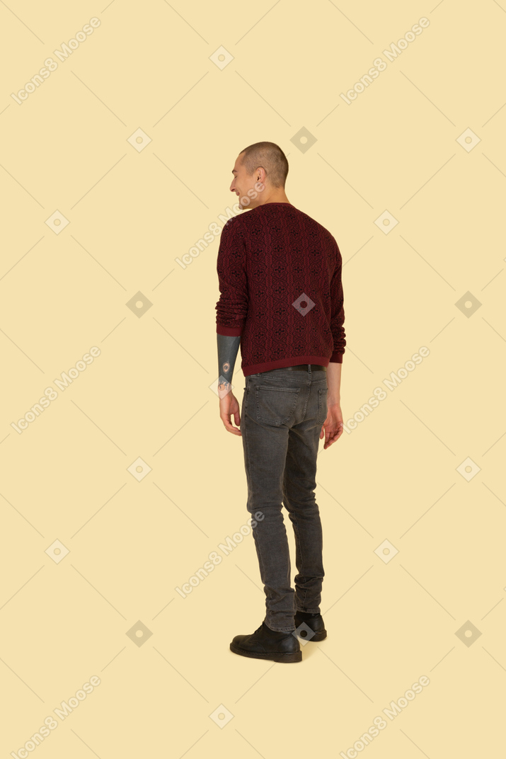 Back view of a laughing young man in casual clothes