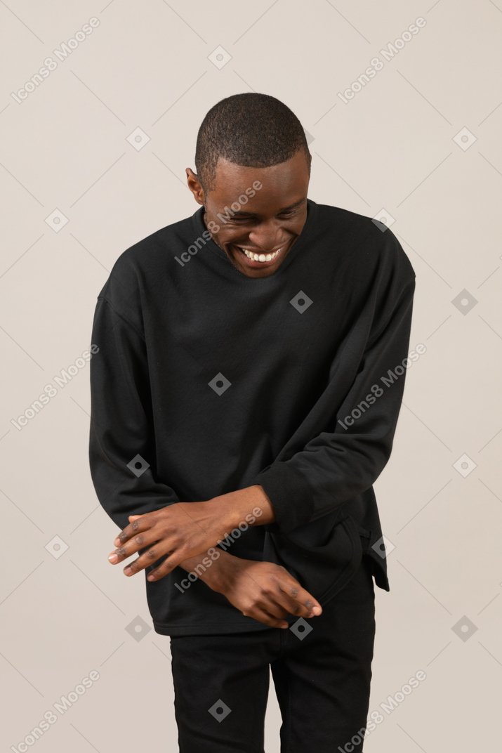 Young man laughing and looking down