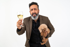 Mature man with a puppy proposing a toast