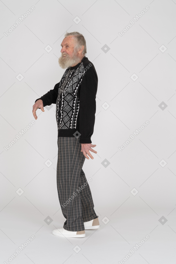 Side view of smiling old man gesturing