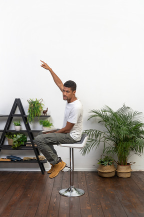 Good looking young man sitting on a chair