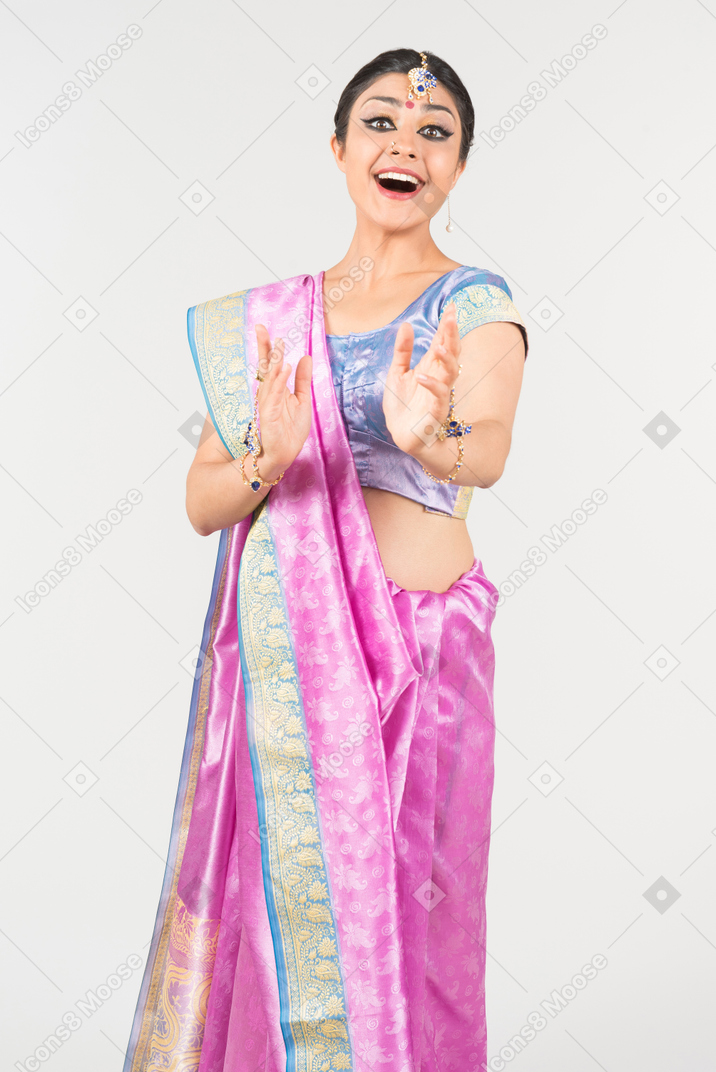 Thrilled looking young indian woman in purple sari