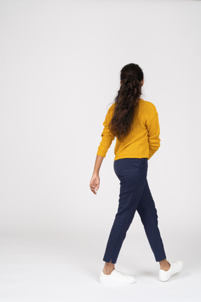 Side view of a girl in casual clothes walking