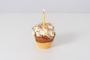 Cupcake with a candle on a white background