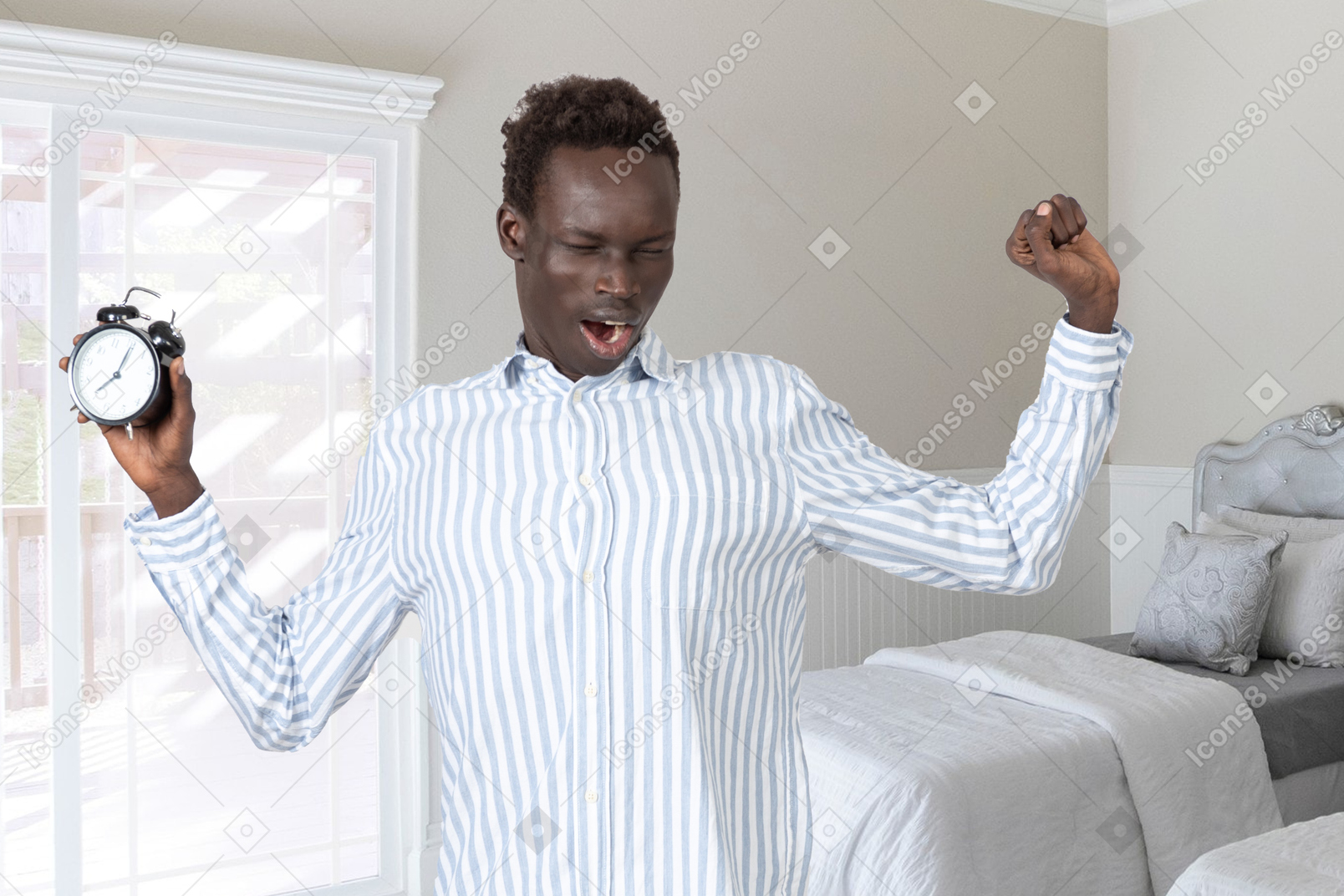 A man holding an alarm clock in his hand