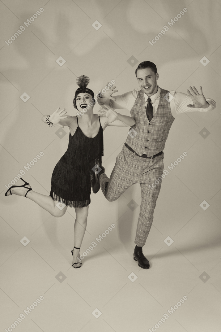 Two cheerful charleston dancers waving with hands