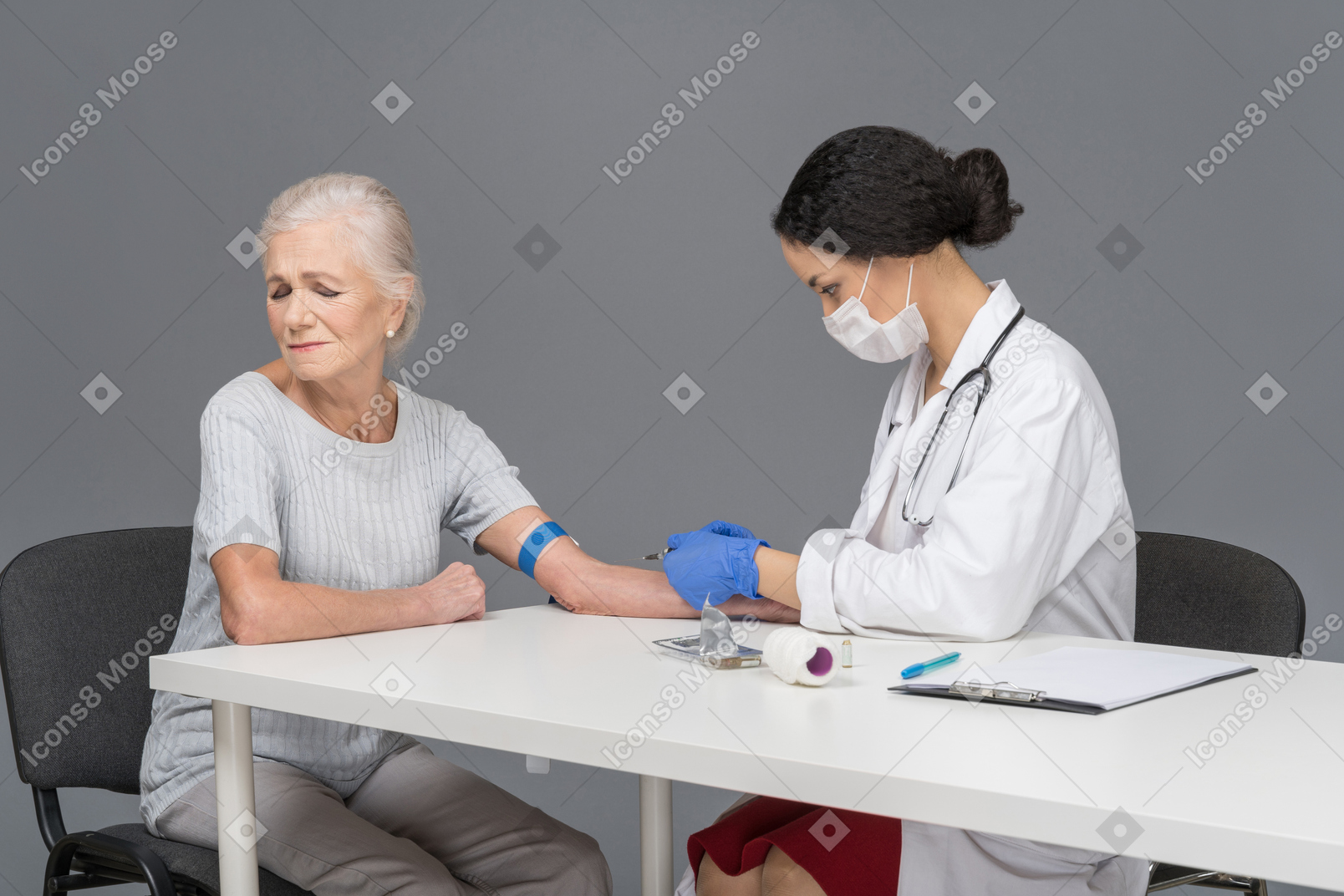Elder woman looks away as doctor makes her injection