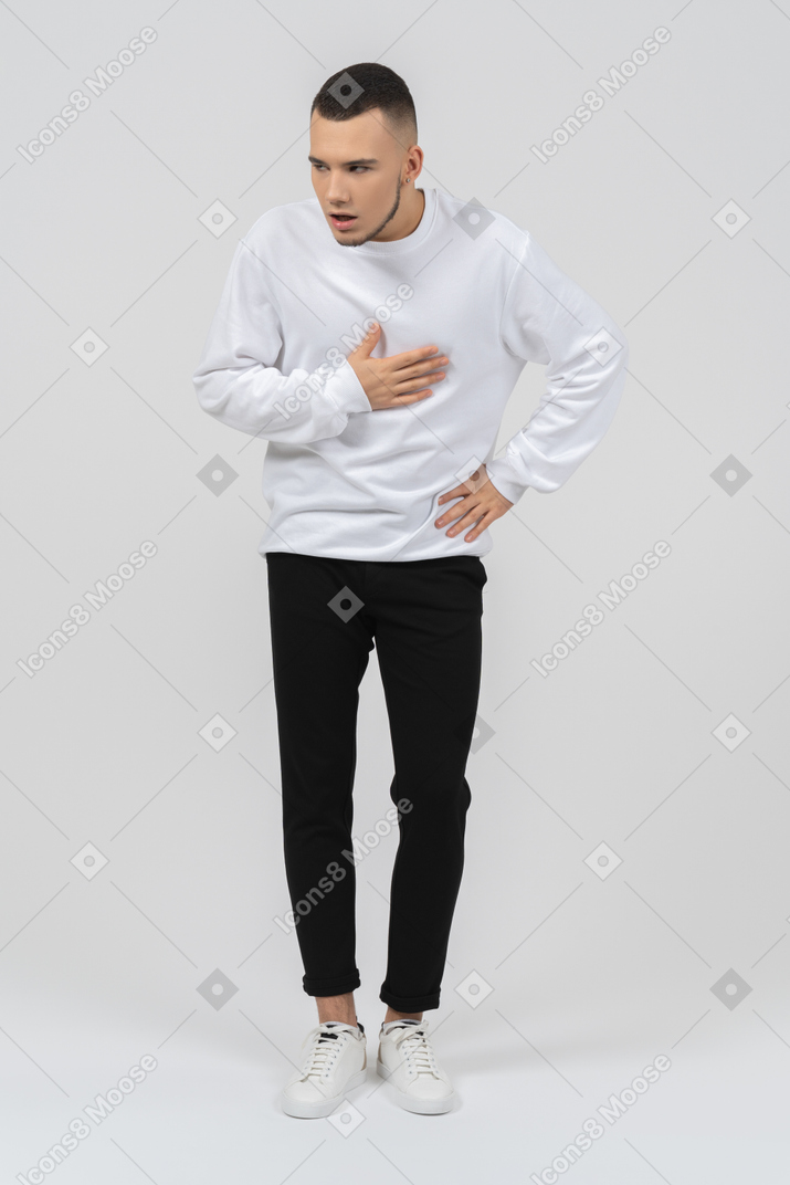 Man in casual clothes with hand on chest