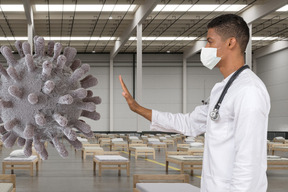 Male doctor in face mask stopping coronavirus