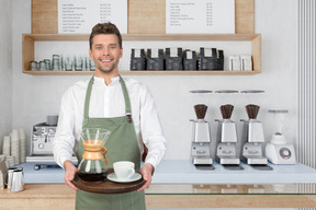 Barista standing at a cafe with freshly brewed coffee