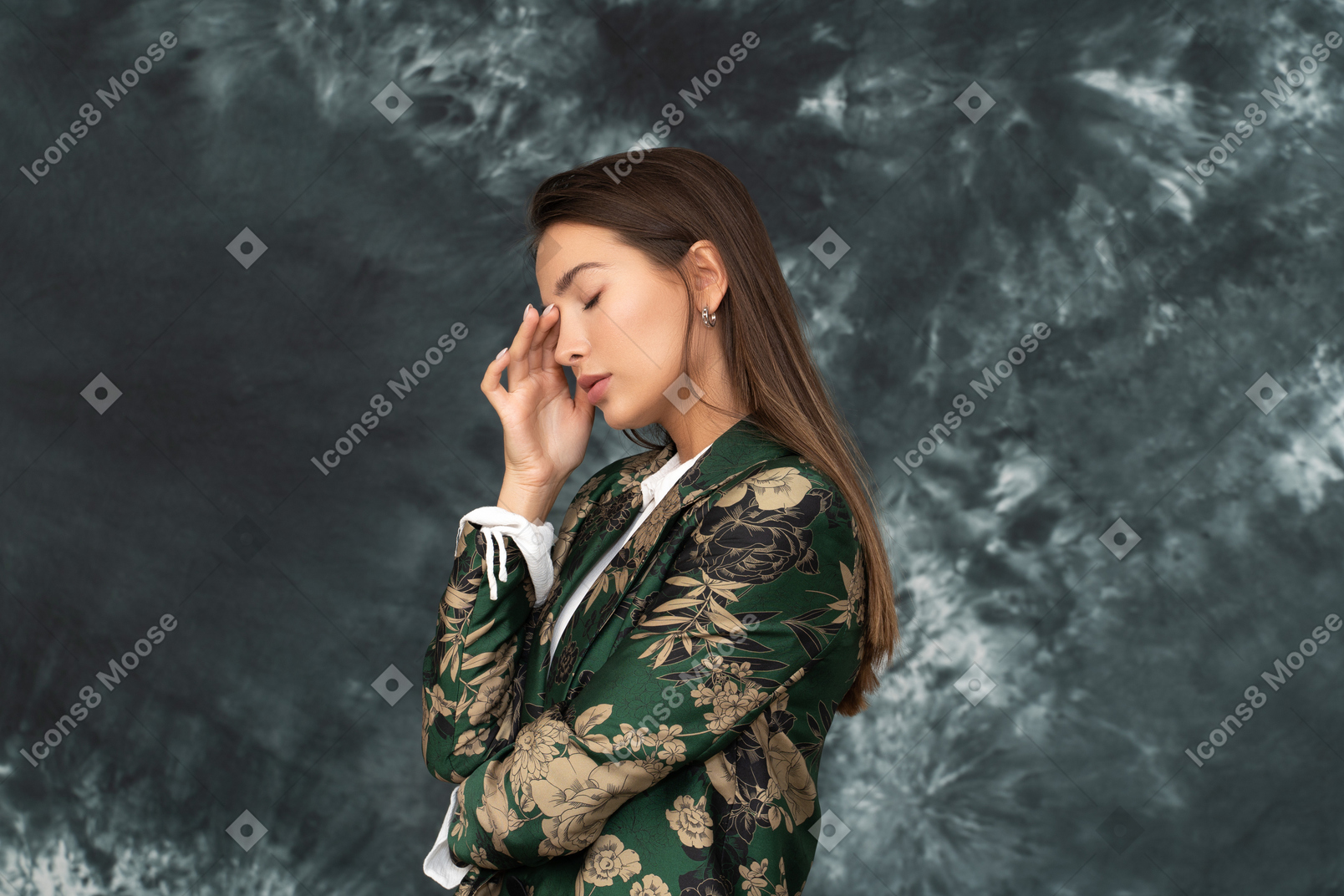 Side shot of female thinking deeply and touching her head