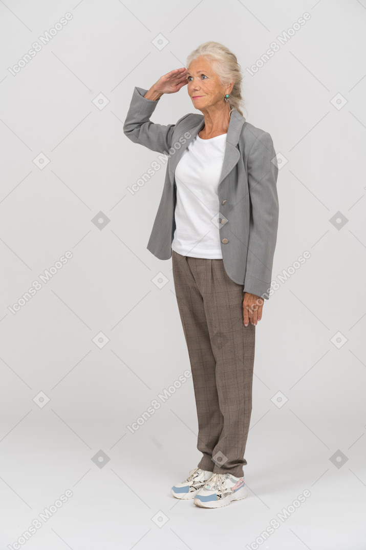 Side view of an old lady in suit saluting with hand