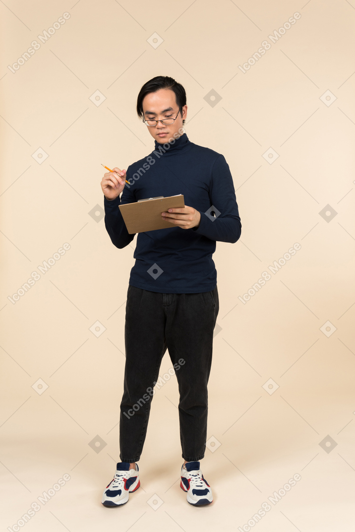 Young asian man holding a clipboard