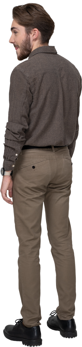 Three-quarter back view of a young man in office clothing licking lips