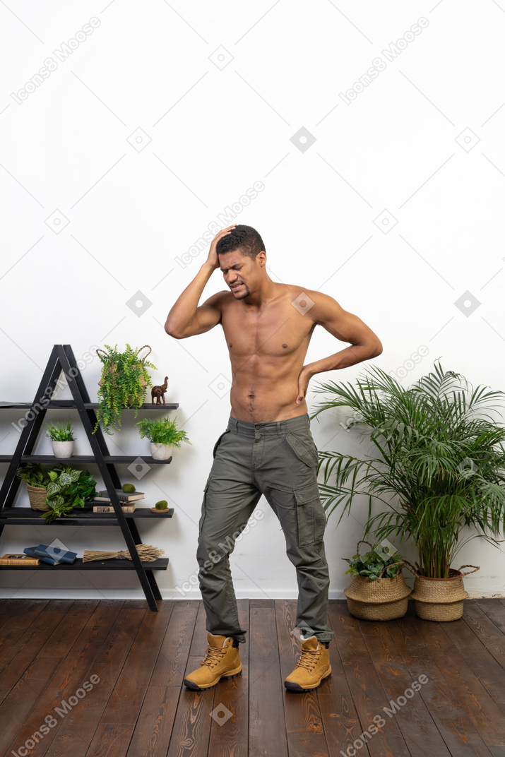 Good looking young muscular man feeling pain