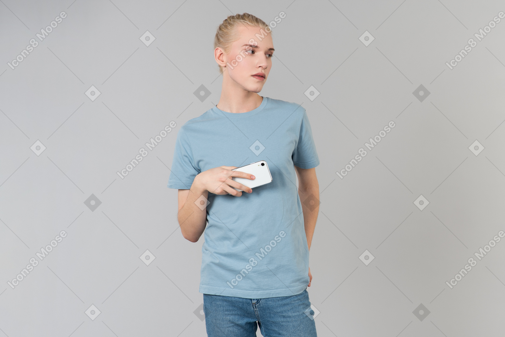 Dreamy young guy holding smartphone