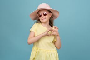 Cute little girl wearing a hat and sunglasses