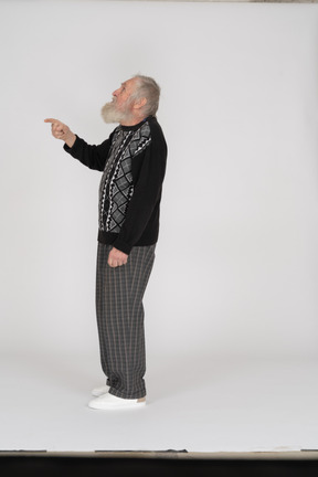 Side view of old man looking up and gesturing