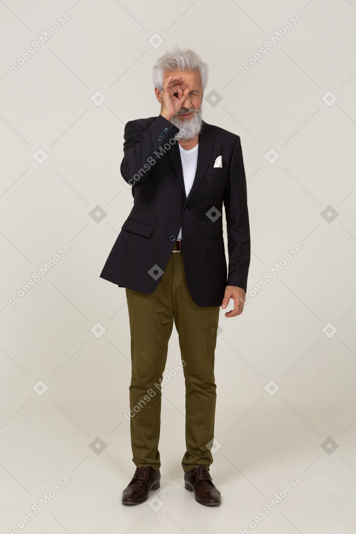 Man in a jacket looking through his hand