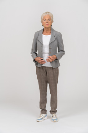 Front view of a serious old lady in suit