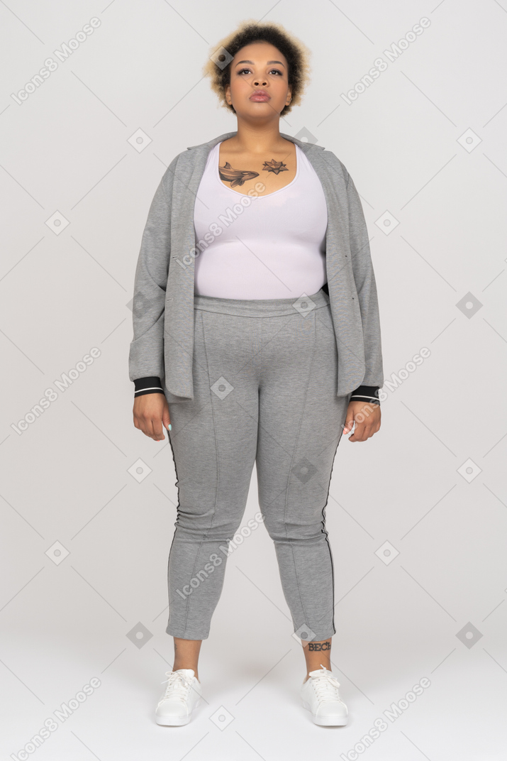Portrait of a tattooed afro woman in gray sport suit