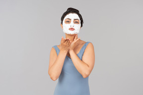 Woman with white mask on sending air kisses