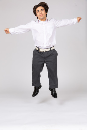 Happy man jumping with spread arms