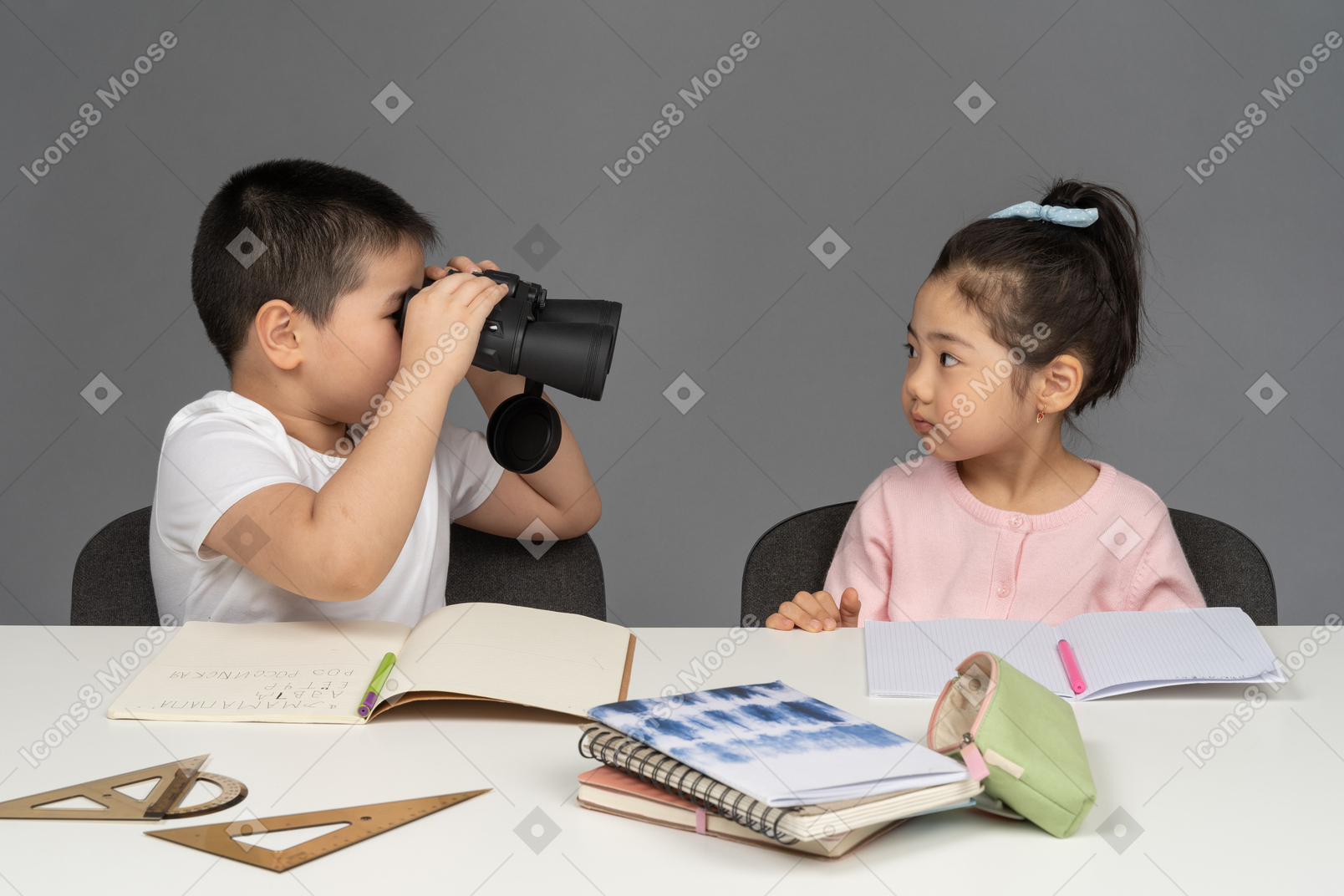 Boy looking at his sister through binoculars