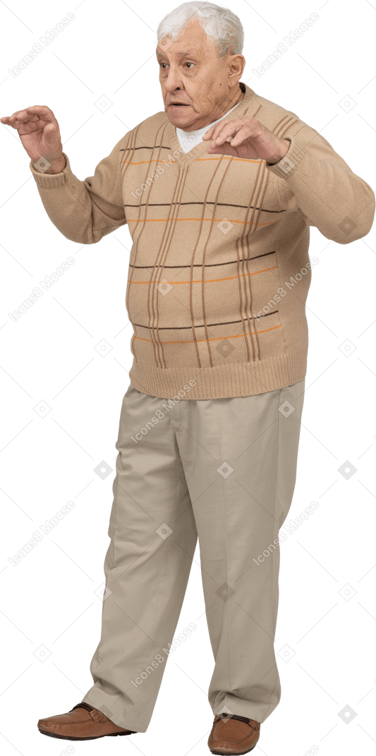 Front view of an old man in casual clothes scaring someone