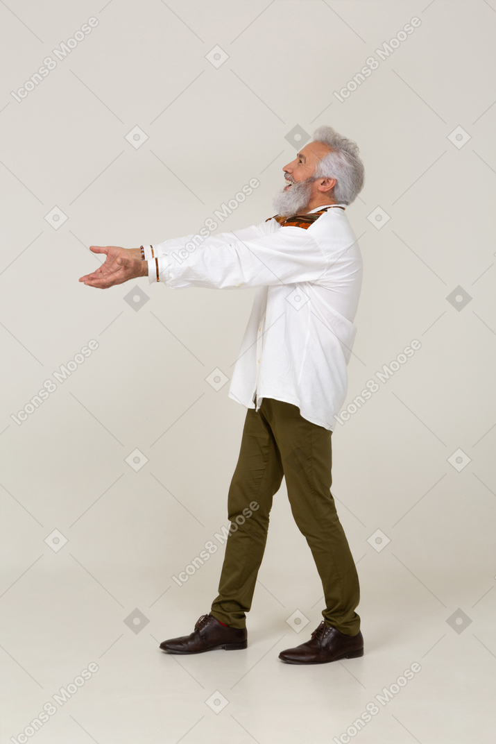Cheerful middle-aged man walking with outstretched arms