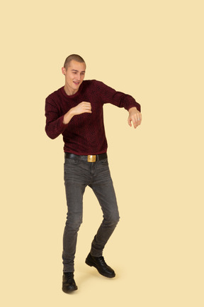 Front view of a young boxing man in red pullover