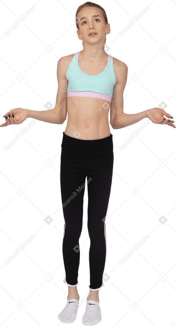 Vista frontal de una jovencita en ropa deportiva levantando manos y razonamiento