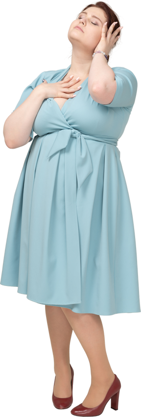 Front view of a woman in blue dress posing