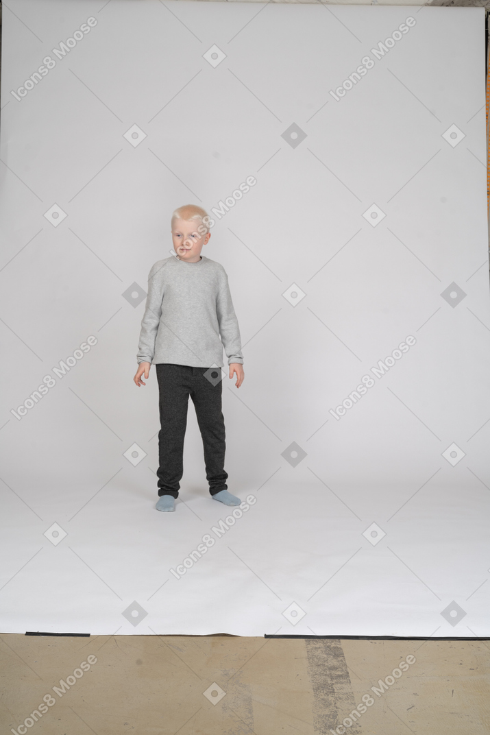 Front view of a shy little boy looking aside