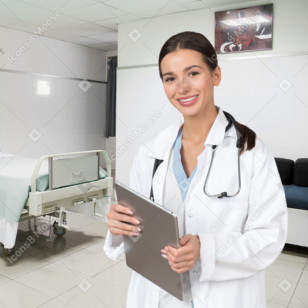 A female doctor holding a clipboard in a hospital room