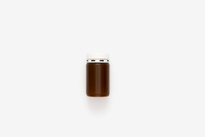 Brown plastic pill bottle with white lid