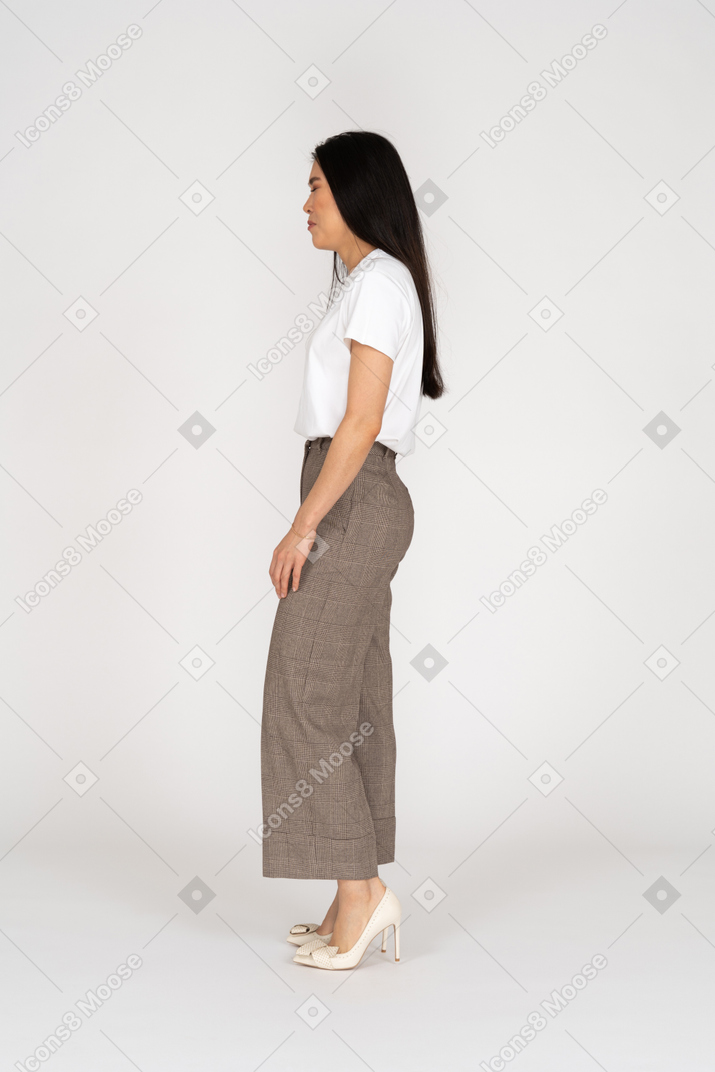 Side view of a crying young lady in breeches and t-shirt