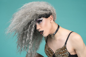 Close-up of a drag queen with hair covering face